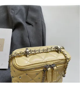 Detailed shot of quilted box bag with silver studs and premium dual zippers
