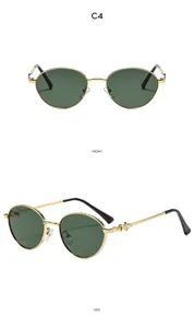 Detail of gold oval sunglasses featuring triangle engraved temples and green lenses