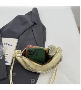 Interior view of yellow crescent bag showing space for phone, wallet and cosmetics