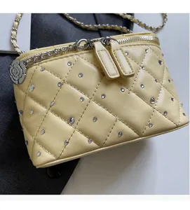 Detailed macro view of quilted mini crossbody bag with crystal studs and camellia charm