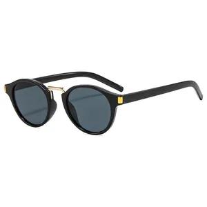 Retro Y2K cat-eye sunglasses with black frames and gold metal accents on white background