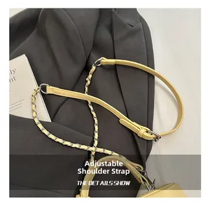 Detail showing the adjustable leather and metal chain shoulder strap in yellow color