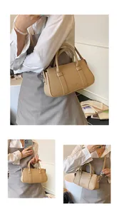 Three-way view of apricot pebbled leather Boston bag with handles and strap