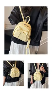 Detail of yellow bow backpack showing versatile carrying styles and PU leather texture