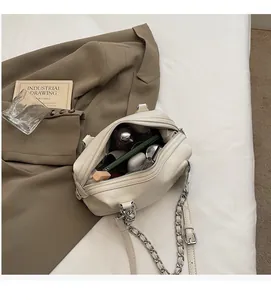 Detail view of cream leather crossbody bag interior showing spacious storage for daily essentials