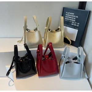 Detail view of crocodile pattern bucket bags in five trendy colors with adjustable straps