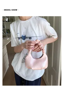Pink glossy faux leather cloud bag with pleated handle and silver bead chain detail