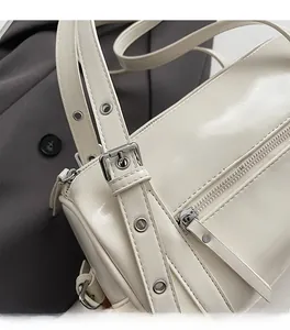 Close-up of premium white glossy leather shoulder bag with sleek silver hardware details