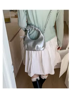 Silver pleated moon bag detail with stylish chain strap shown from a back view