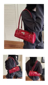 Détail du sac bowling rouge montrant le cuir brillant et le pendentif en cœur