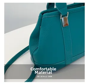 Macro shot of lychee grain leather texture and premium stitching on green handbag
