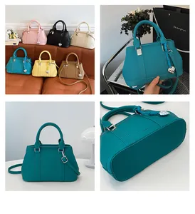 Detail view of lychee pattern leather bags with heart charms and detachable straps