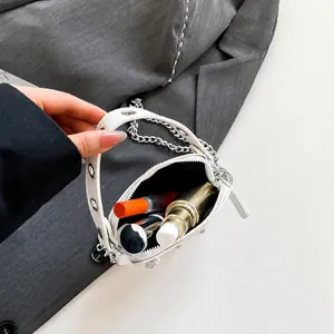 Internal view of a white mini bag showing space for lipstick and small perfume bottle
