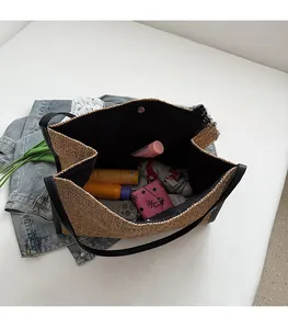 Top view of large straw tote bag interior showing spacious lining and magnetic clasp