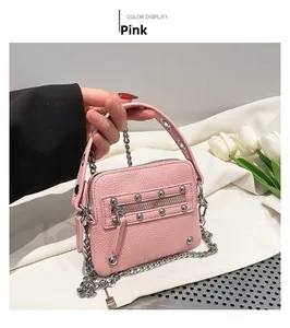 Detail of pink mini chain bag with lychee texture and metallic rivet accents