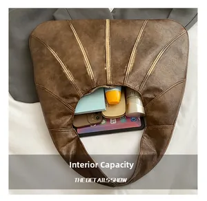 Detailed top view of brown leather tote bag interior showing large storage capacity
