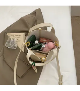Interior view of the cream tote bag showing spacious capacity for phone, umbrella and makeup