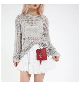 Close-up of a red textured leather mini bag with dual silver zippers and belt loop clip