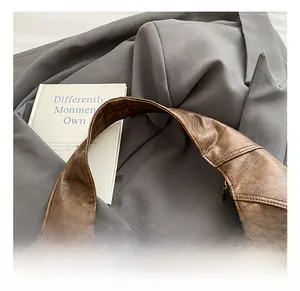Detail of vintage brown leather patchwork tote bag with zipper and fabric lining