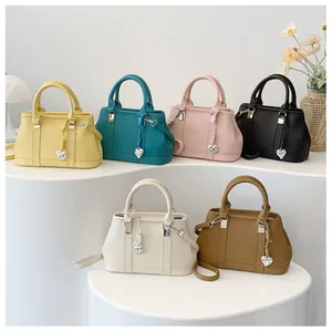 Litchi pattern leather handbags in six colors with heart pendant and crossbody straps