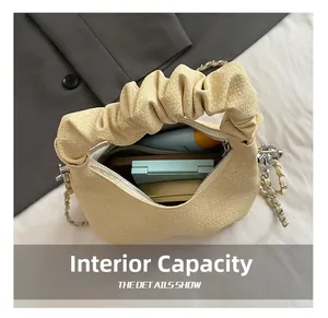 Interior view showing the capacity of a beige pleated cloud bag with daily essentials