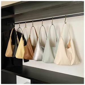 Hobo tote bags in seven colors with lychee grain texture hanging in a row
