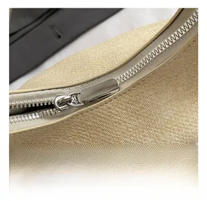 Detailed close-up of premium silver metal zipper and woven texture on cloud bag