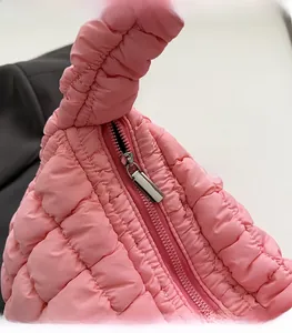 Detail of pink quilted cloud bag showing smooth silver metal zipper and soft nylon fabric