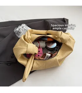 Interior view of the yellow pleated bag showing capacity for umbrella and daily items