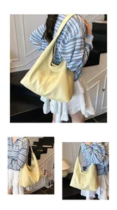Close-up of creamy yellow tote bag showing soft litchi texture and spacious interior