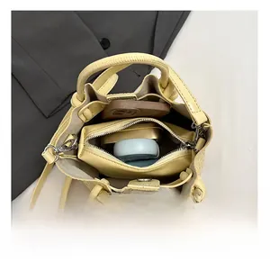 Top view of yellow woven bucket bag showing spacious interior with zipper compartment