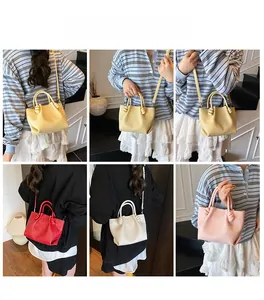 Detail of multi-color woven tote bags showing knot handle and woven leather texture