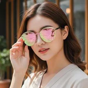 Chic cat eye sunglasses with pink-green gradient lenses and gold metal frames on a model