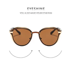 Detailed front view of cat-eye sunglasses with gold metal frame and gradient brown lenses