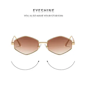Detailed front view of gold hexagonal metal frame sunglasses with brown gradient lenses