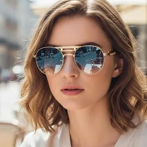 Lunettes de soleil aviateur en métal doré avec verres dégradés portées par un mannequin