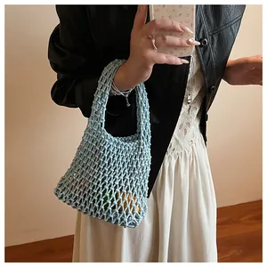Detail showing hollow knit pattern and woven texture of the light blue summer handbag
