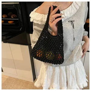 Detail of a black hollowed-out knit tote bag used for carrying fresh fruit in a kitchen