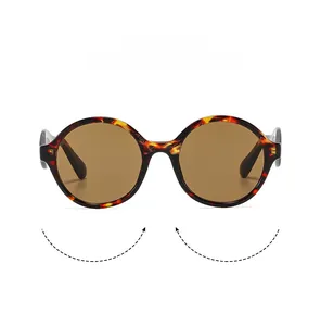 Detailed front view of retro round tortoiseshell sunglasses with brown lenses and frame texture