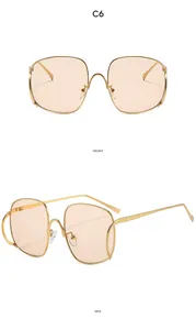 Vues de face et de profil des lunettes dorées à grands verres orange clair