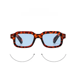 Detail shot of tortoiseshell square sunglasses with light blue lenses and silver studs
