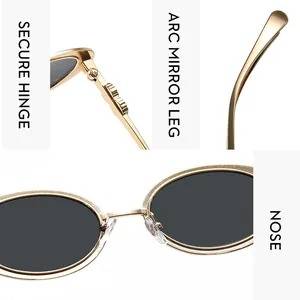 Detail view of oval sunglasses with gold metal hinges and ergonomic curved temple arms