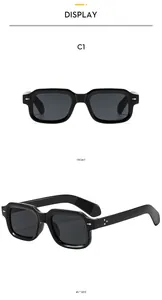 Close-up of square black sunglasses with metal stud accents and glossy C1 finish
