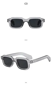 Detail view of transparent grey square frame sunglasses with metal studs and black lenses