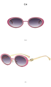 Detail of pink oval sunglasses with gold metal temples and purple gradient lenses