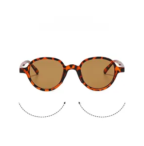 Detailed close-up of retro round tortoiseshell sunglasses with brown tinted lenses