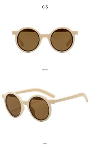 Vues de face et de profil de lunettes de soleil rétro rondes beige avec verres bruns