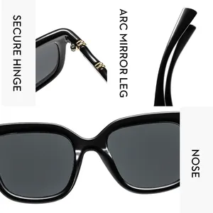Detail of vintage square sunglasses featuring reinforced gold hinges and curved temples