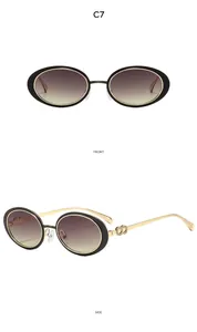 Detail view of oval retro sunglasses with black-gold metal frame and gradient purple lenses