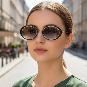 Vintage oval sunglasses with black and gold frames and gradient brown lenses for women
